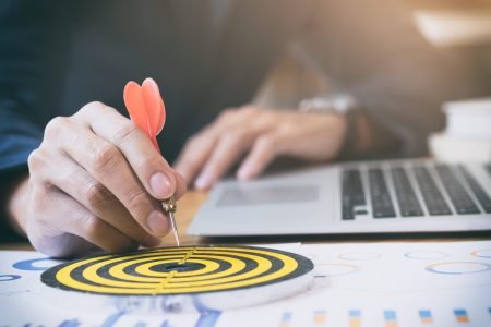 Business strategy success target goals. Businessman holding red dart push on target. Business strategy planning success target goals. Business development concept